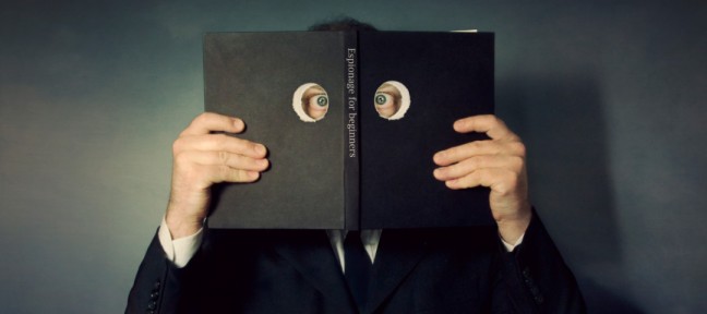 A man who is spying through a book (Scott MacBride/Getty Images)